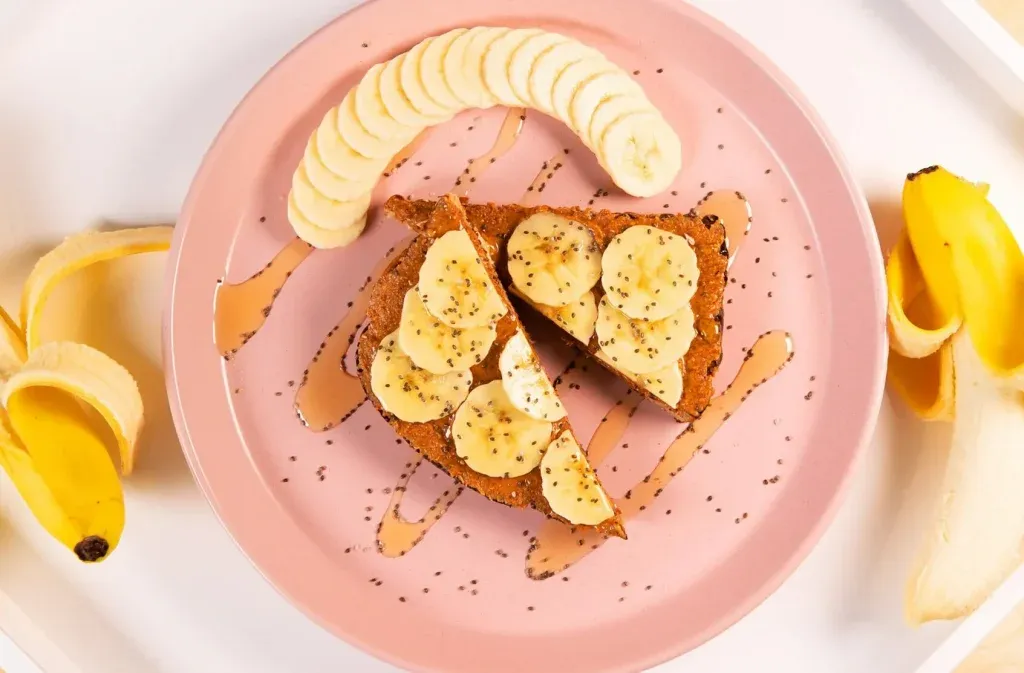 Sourdough toast topped with sliced banana and honey